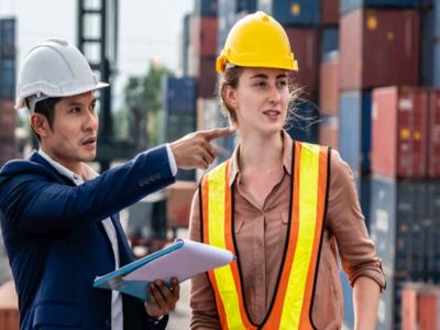 Man and woman in cargo terminal working