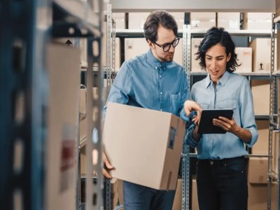 man and woman looking at tablet in depot